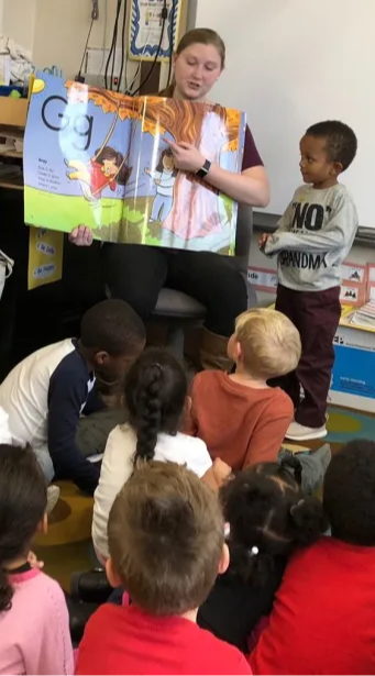 teacher reading a book to the class