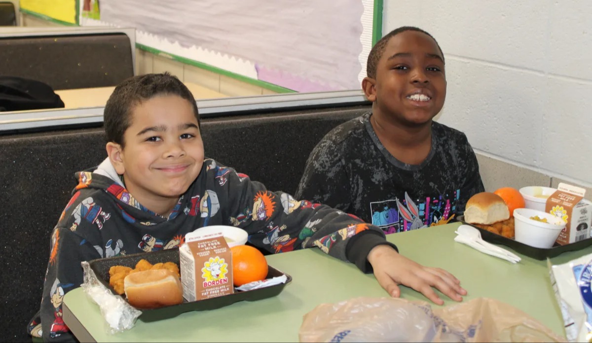 student smiling having lunch at cafeteria