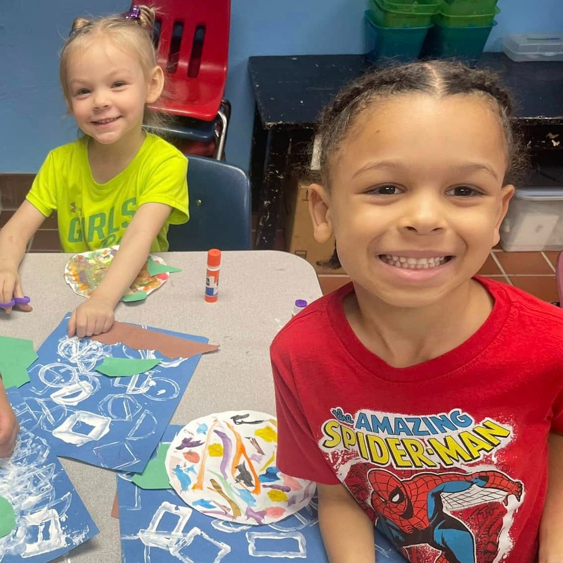 two students making art pages