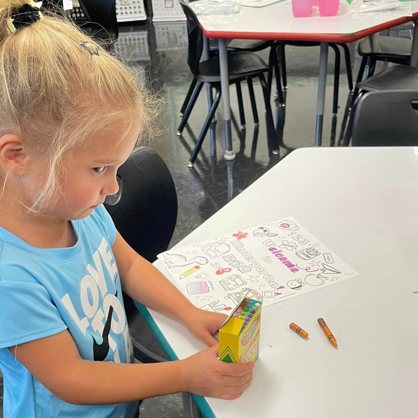 young female student with crayons