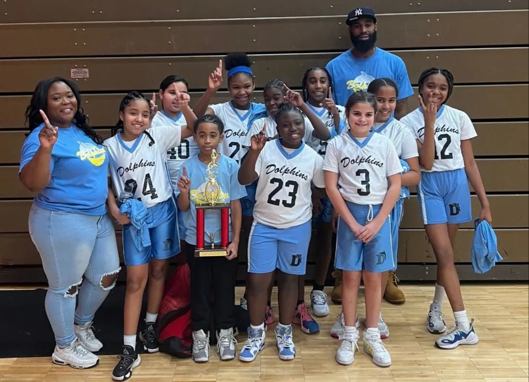students and coaches holdig trophy 