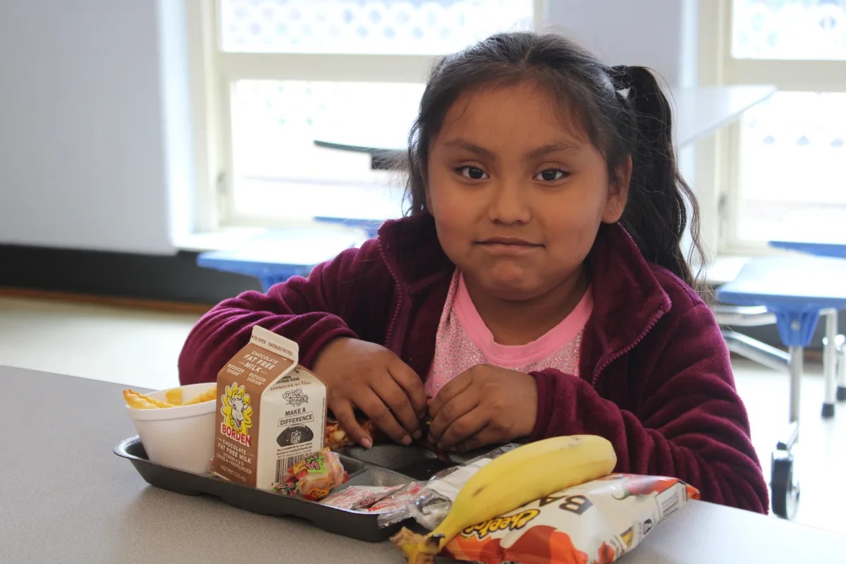 student smiling having lunch at cafeteria