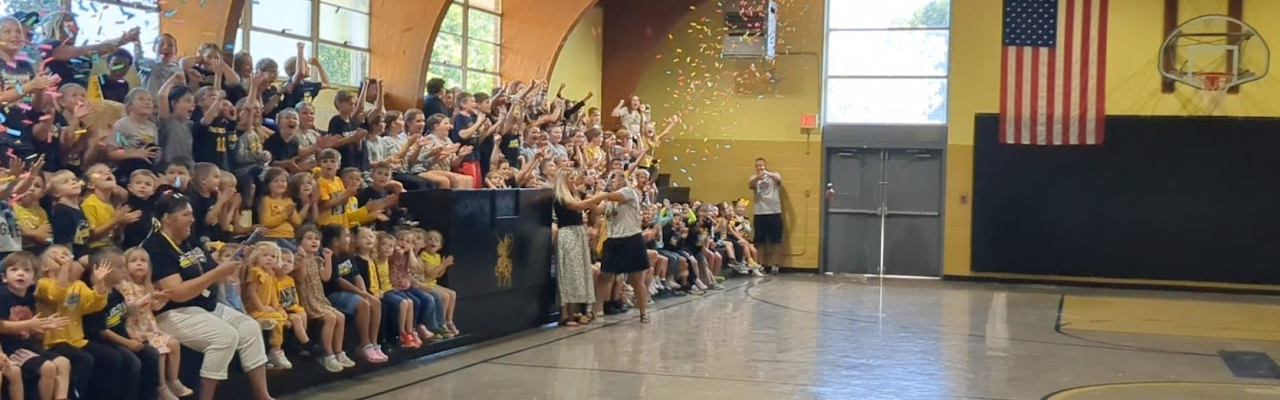 students and staff in gym.