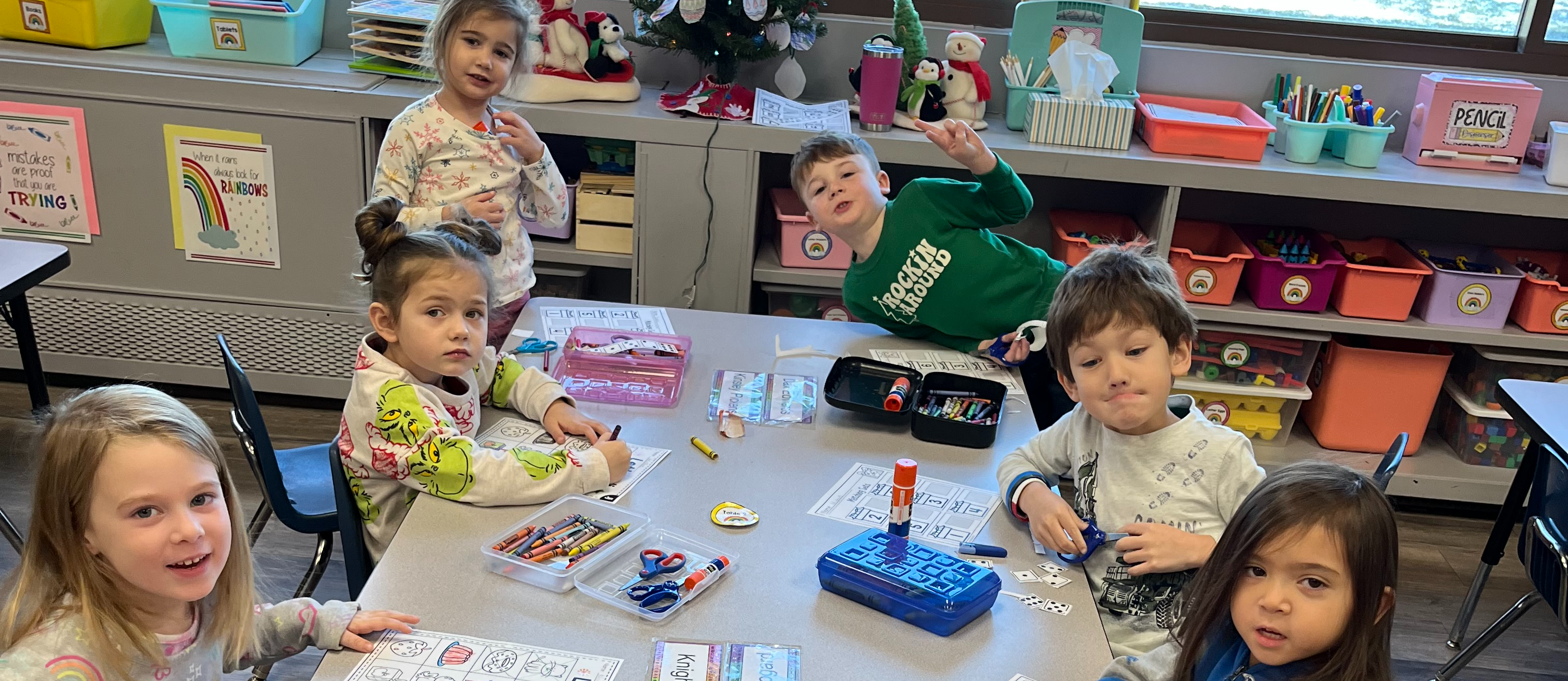 Cabrini pre-school 4 year olds working together at a table during class