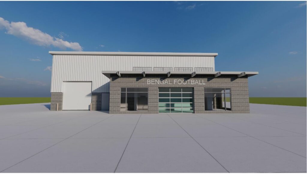 A modern building design featuring a large glass front, stone accents, and a flat roof, set against a clear blue sky.