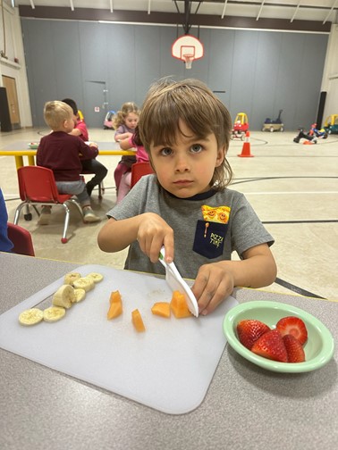 student slicing fruit