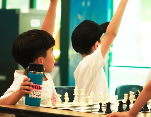 students raising hands