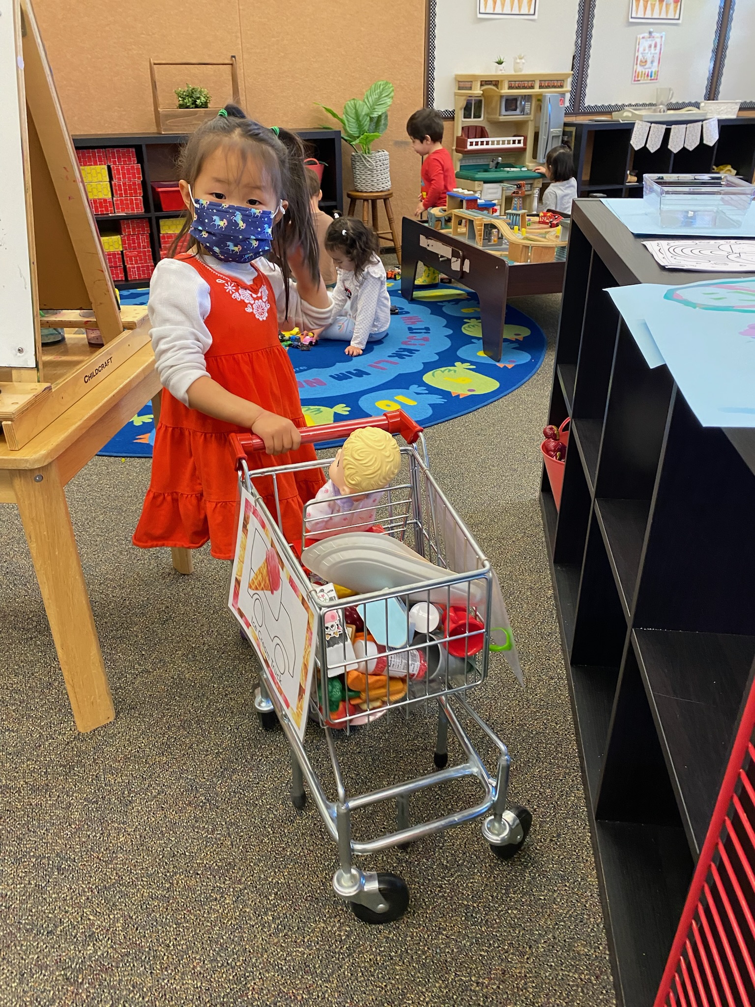 girl playing with plastic groceries