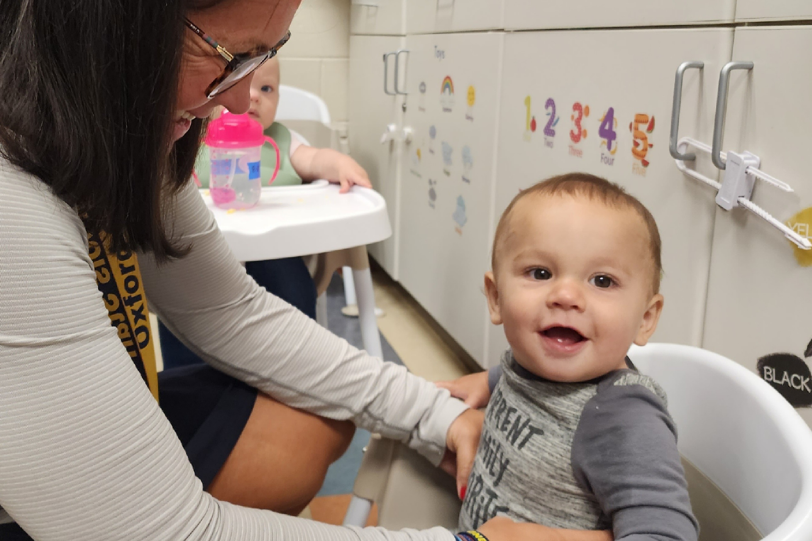 teacher with baby smiling