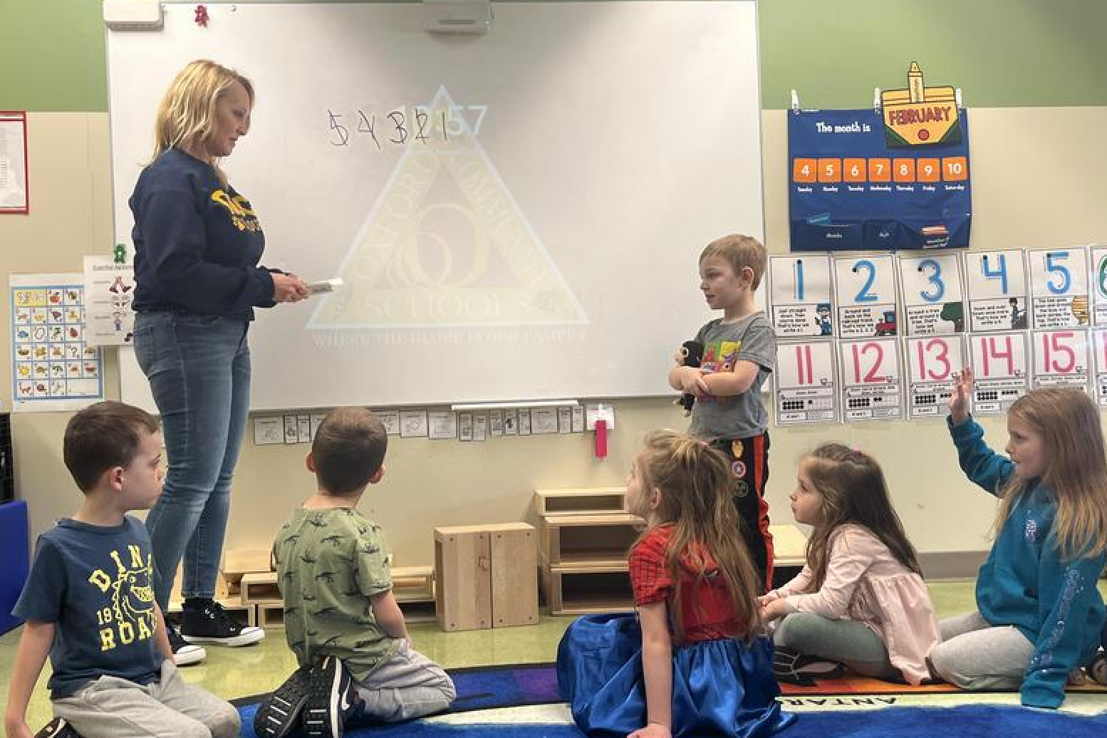 Teacher in front of preschool class teaching a lesson.