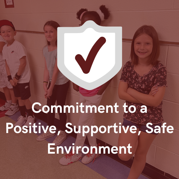 Commitment to a Positive, Supportive, Safe Environment in foreground with faded background of students lined up on a wall in the hallway