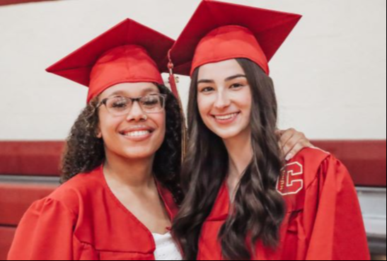 Image of two students in their graduation cap and gown