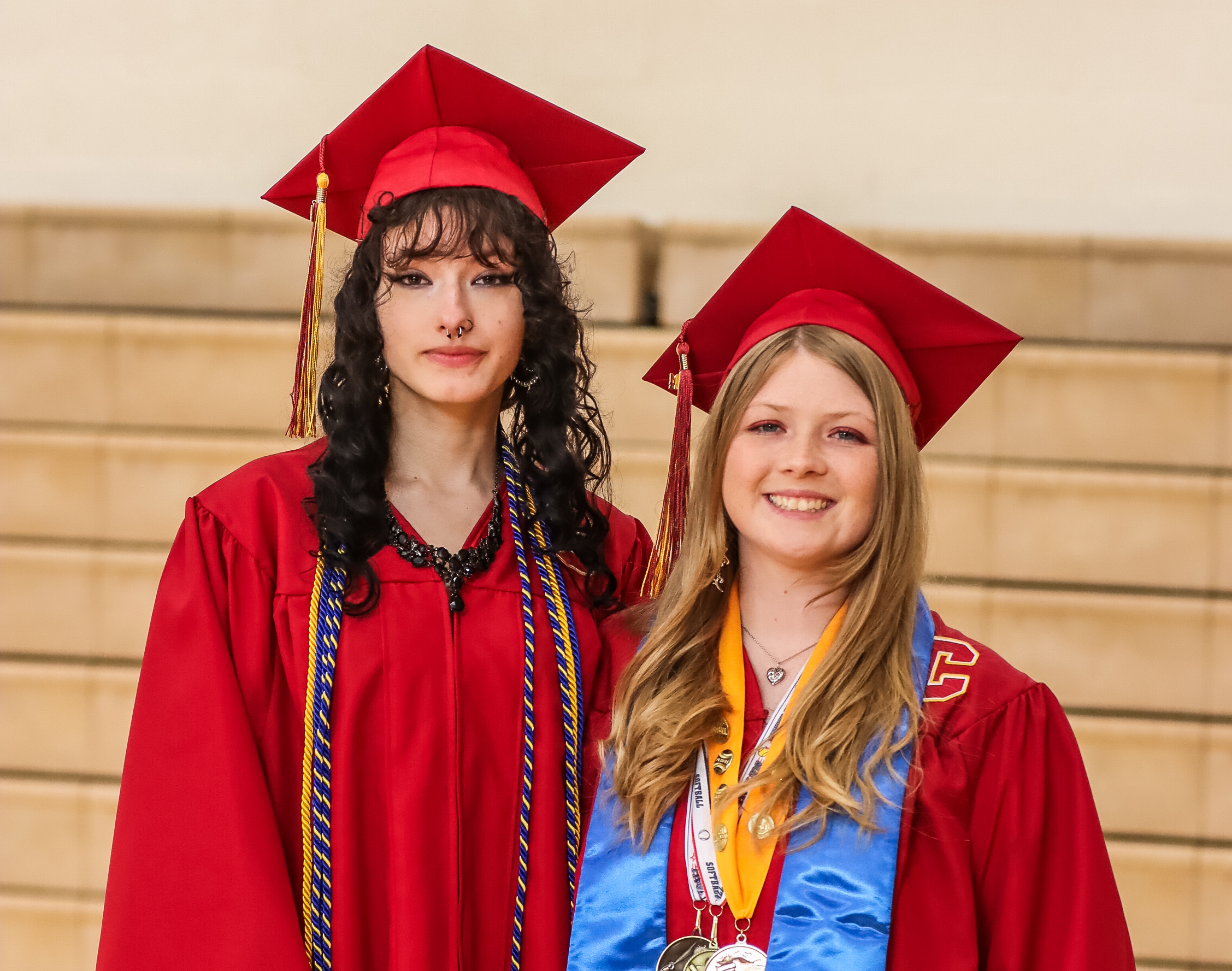 Image of two students in their graduation cap and gown