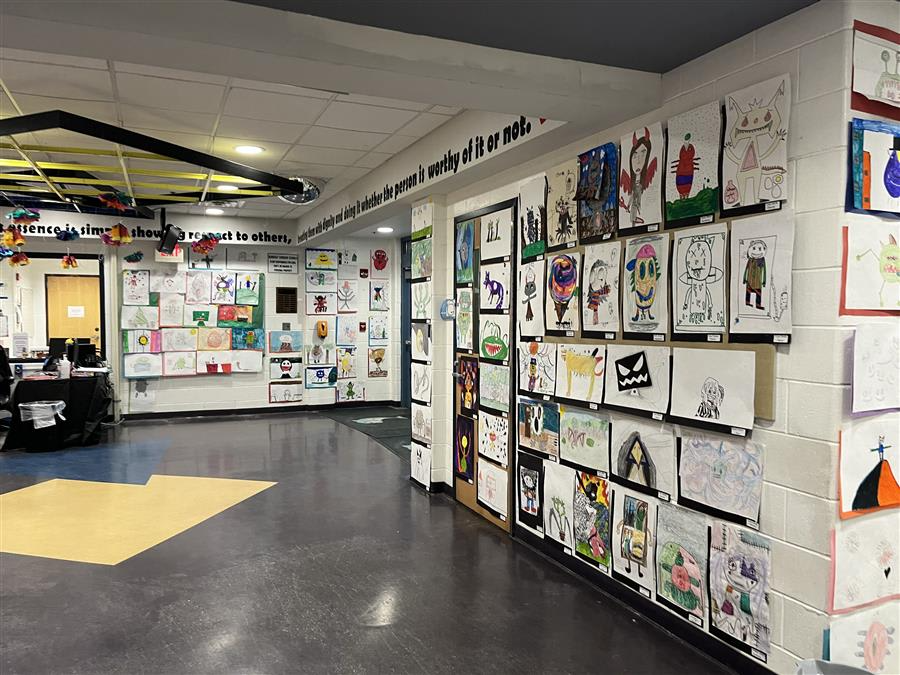 A vibrant hallway adorned with numerous colorful paintings lining the walls, creating an inviting and artistic atmosphere.