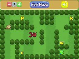 A colorful maze game featuring a red character navigating through green bushes, with letters 'p', 'k', 'c', and 'w' placed throughout the maze.