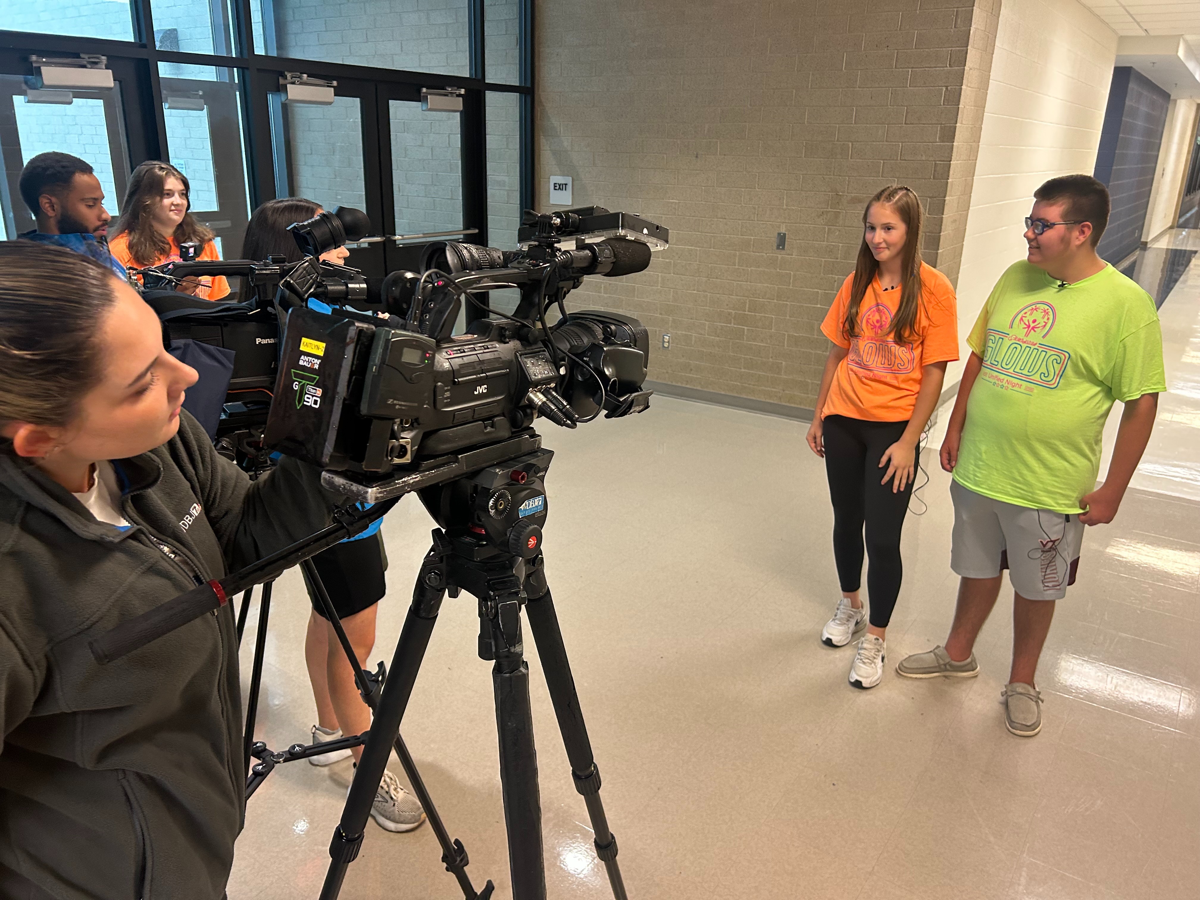Two students being interviewed by news stations