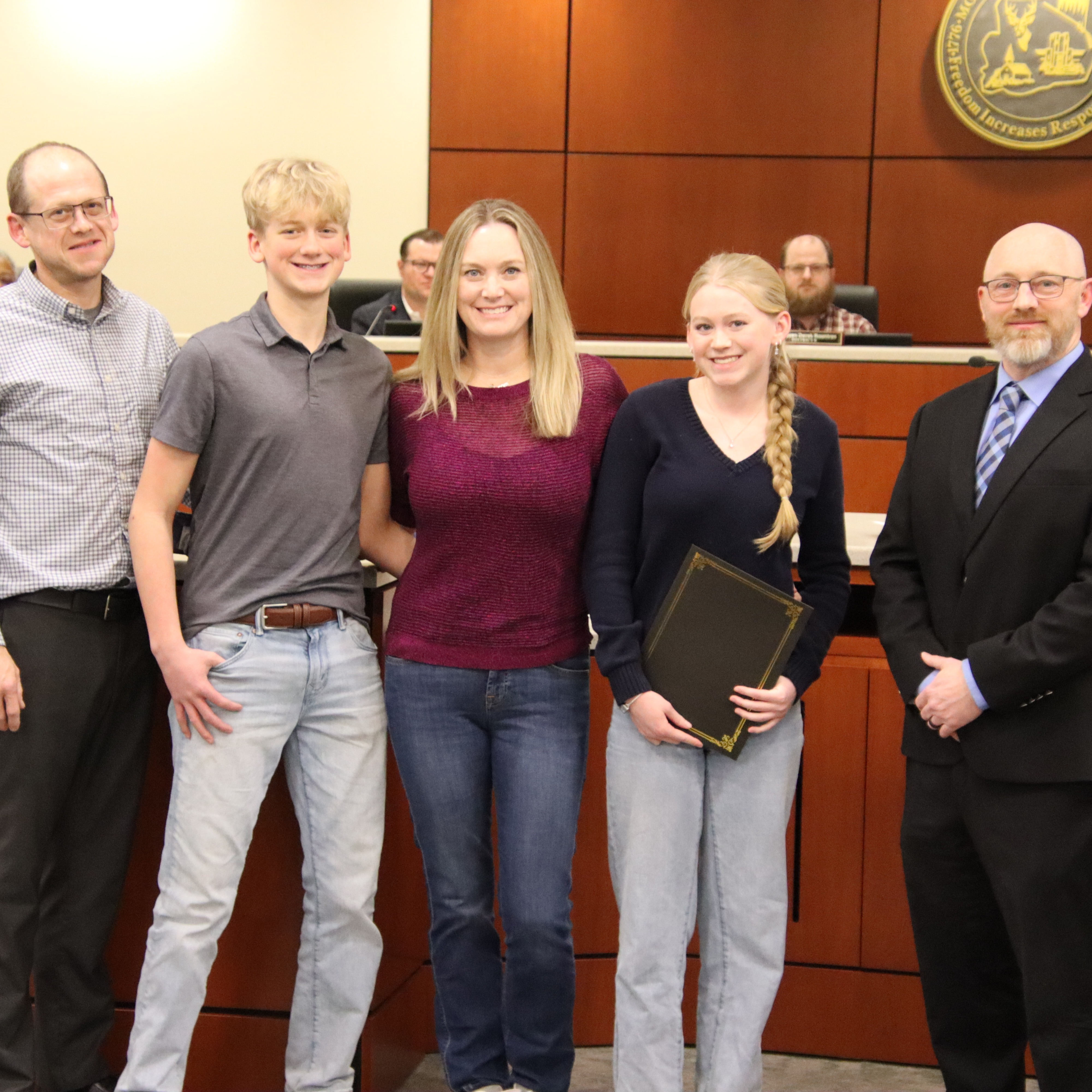 Sophia Wender standing with family