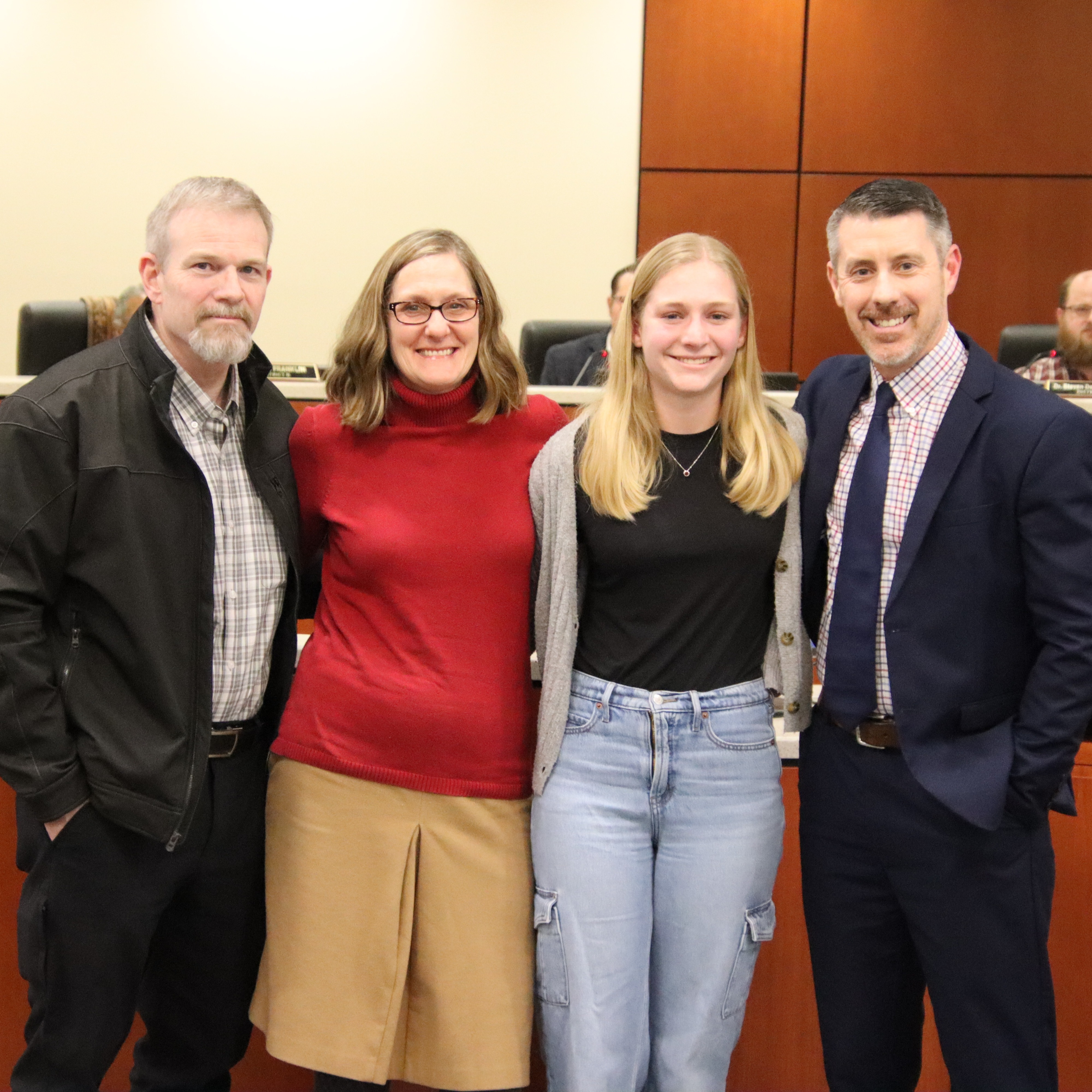Addison Mecom standing with family