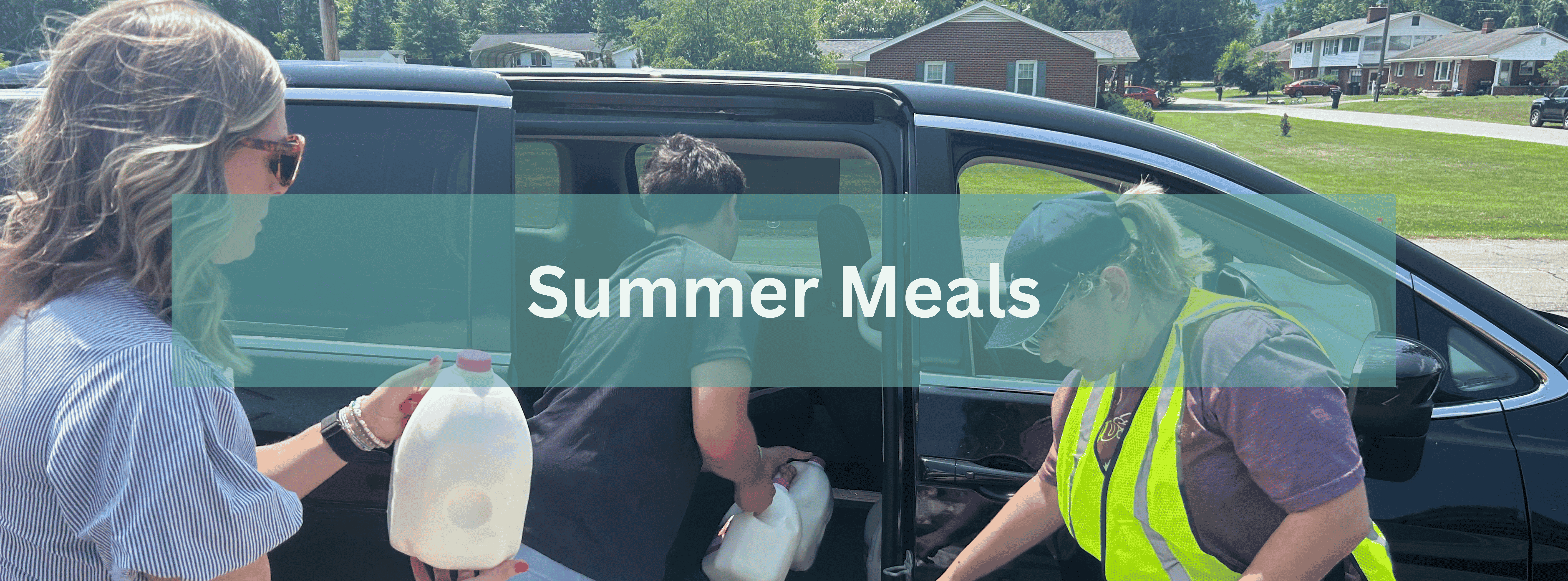 Photo of a car being loaded with food with text overlay saying "summer meals"