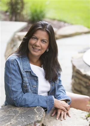 Woman Smiling and wearing a white t-shit and a jean jacket