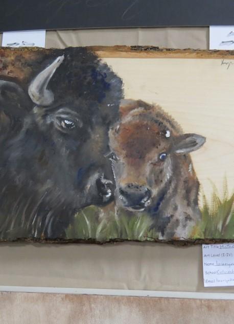 A painted depiction of a bison and its calf, with the adult bison's head close to the calf, set against a grassy background.