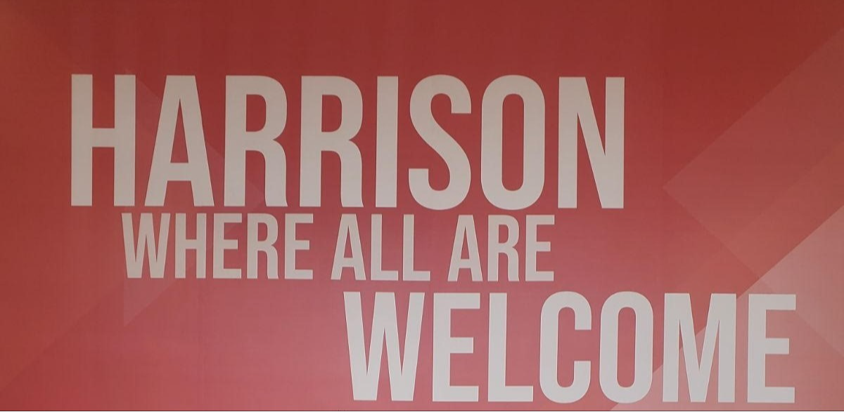 Creekside welcome sign reads, "Harrison, where all are welcome."