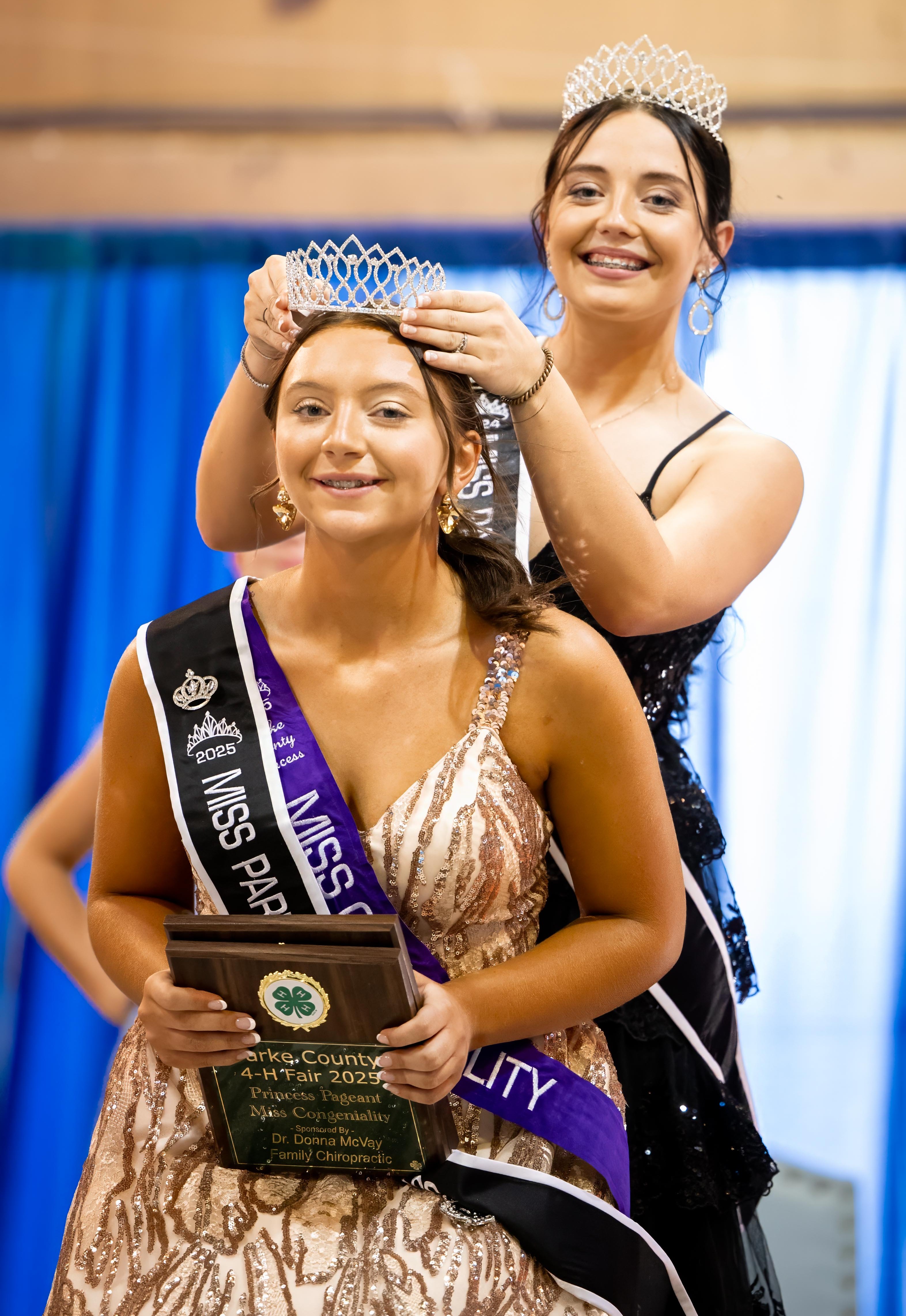 a girl wearing a crown crowning a new princess