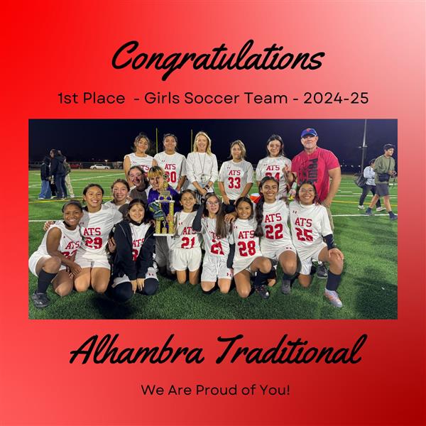 A group photo of a girls soccer team celebrating their 1st place win, with a trophy, on a field at night, surrounded by supportive coaches and teammates, with a congratulatory message in the background.