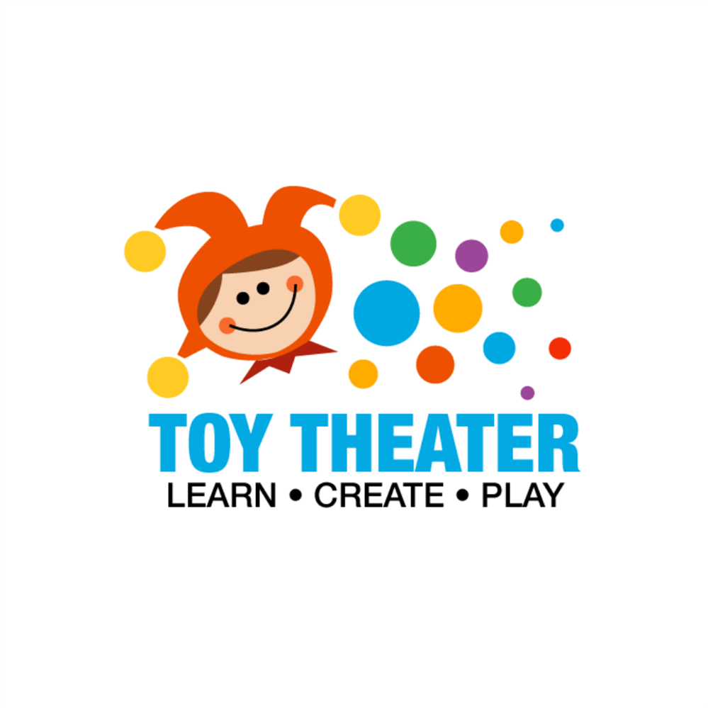 A colorful logo featuring a smiling cartoon character with a jester hat, surrounded by multicolored circles, and the text 'TOY THEATER' along with the phrases 'LEARN • CREATE • PLAY'.