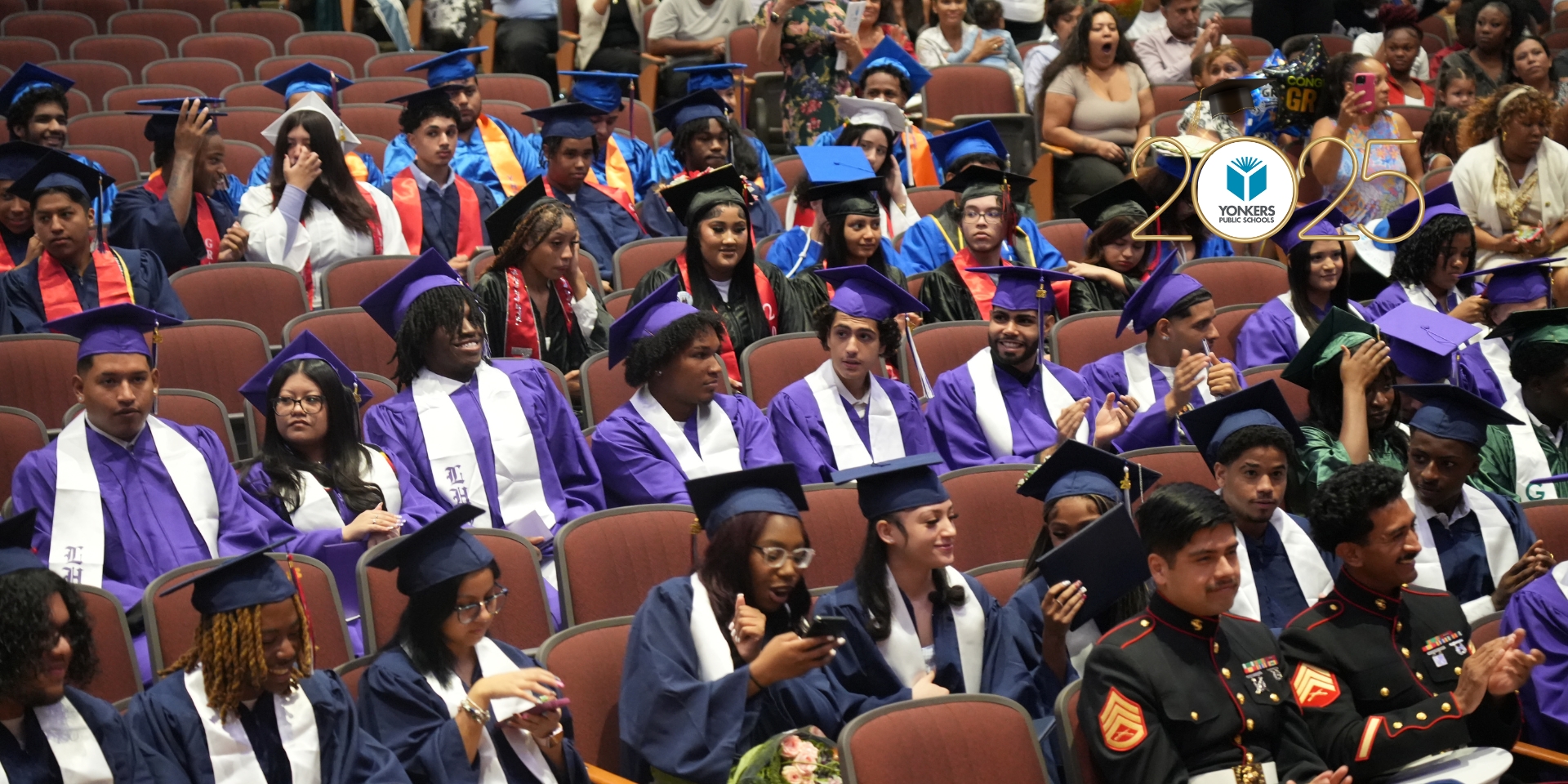 The Class of 2025 Summer Graduates assembled in their colorful gowns