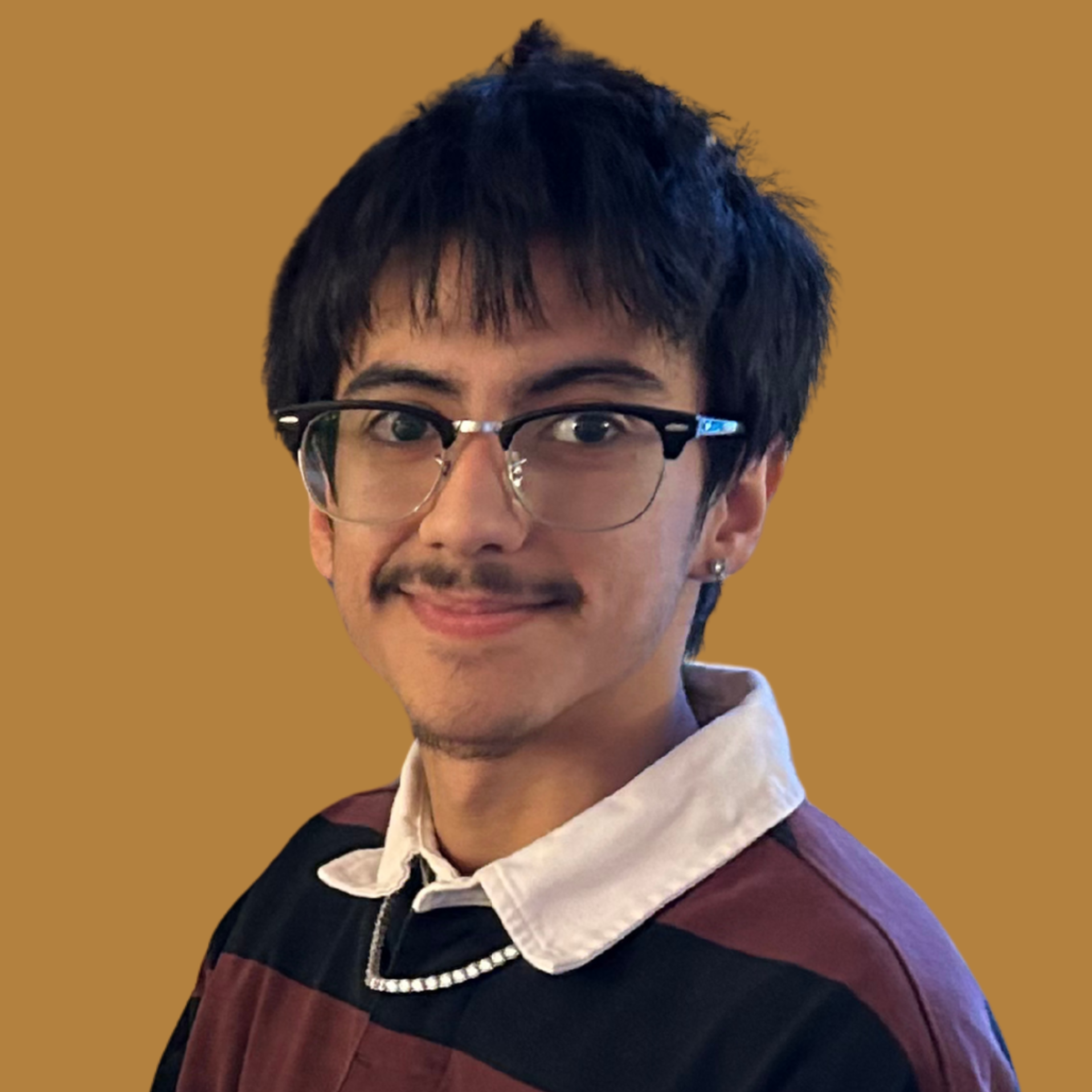 A person with short black hair wearing glasses and a striped shirt poses against a warm brown background.