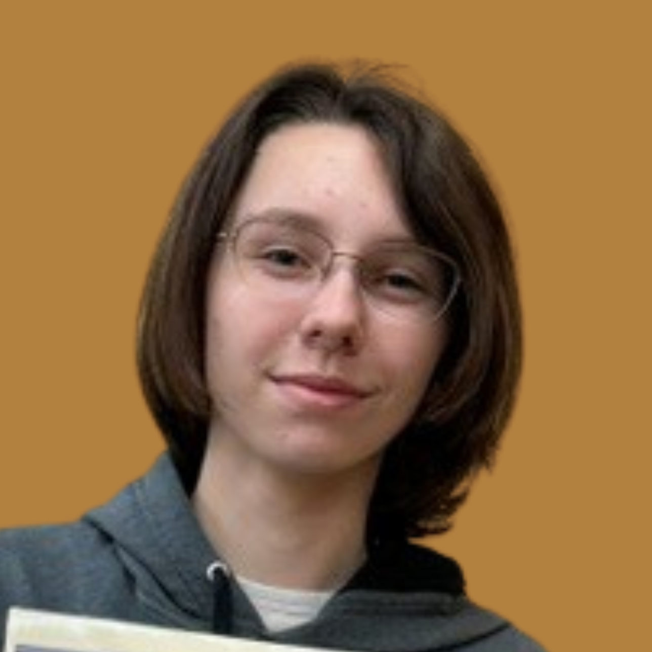 A person in a gray sweatshirt and glasses holds a certificate with a floral design and text.