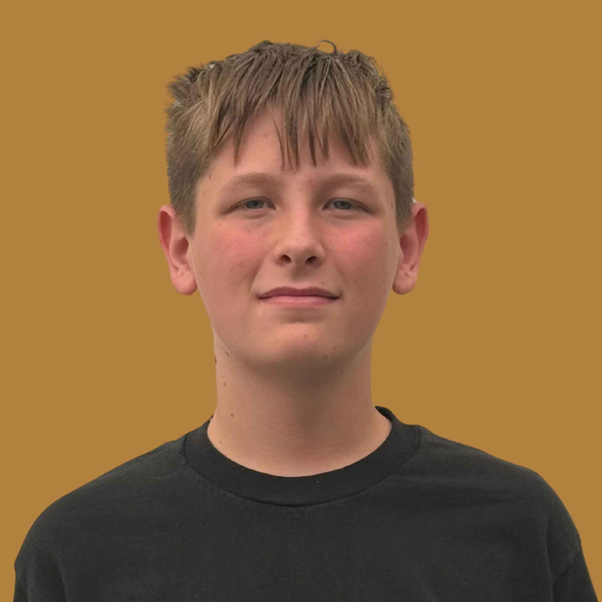Boy with short blond hair stands in front of brown background, wearing a black shirt with white Chocolat logo.