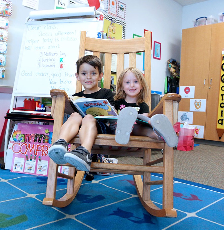 students reading in a rocking chair