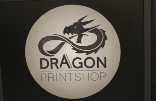 A circular logo featuring a stylized dragon above the text 'DRAGON PRINTSHOP' with an infinity symbol incorporated into the design.