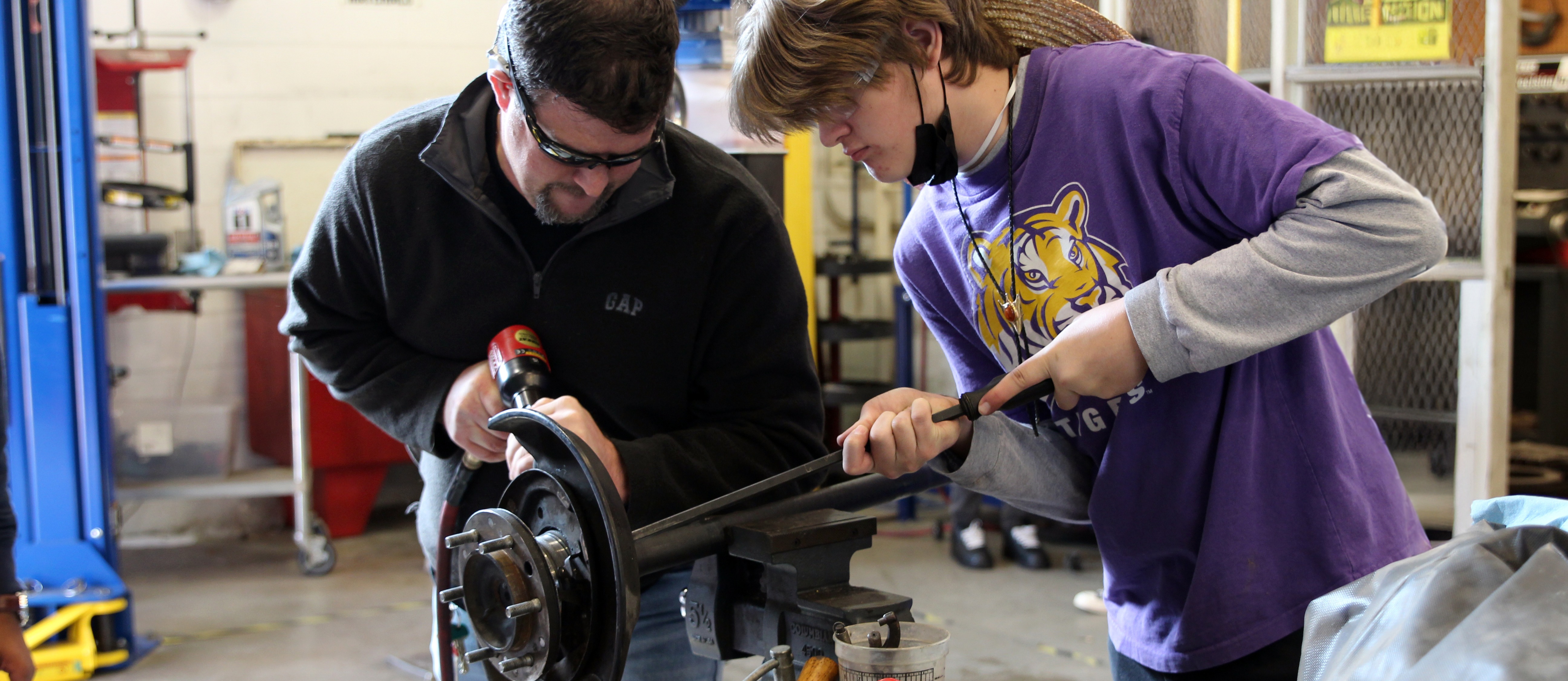 McNeil High School auto tech students working on an axle