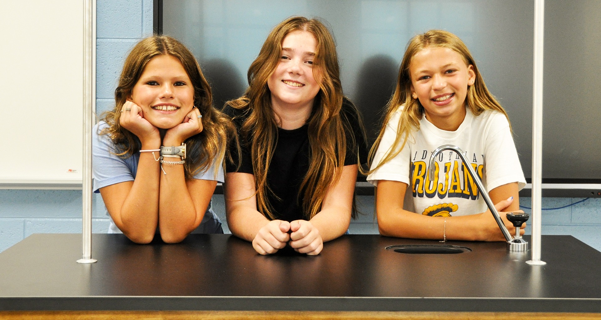 students pose in classroom