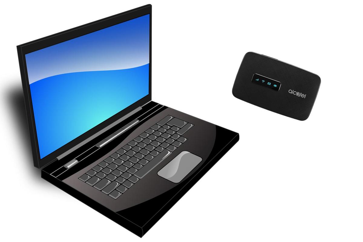 A laptop computer positioned beside a wireless router, illustrating a modern workspace setup.