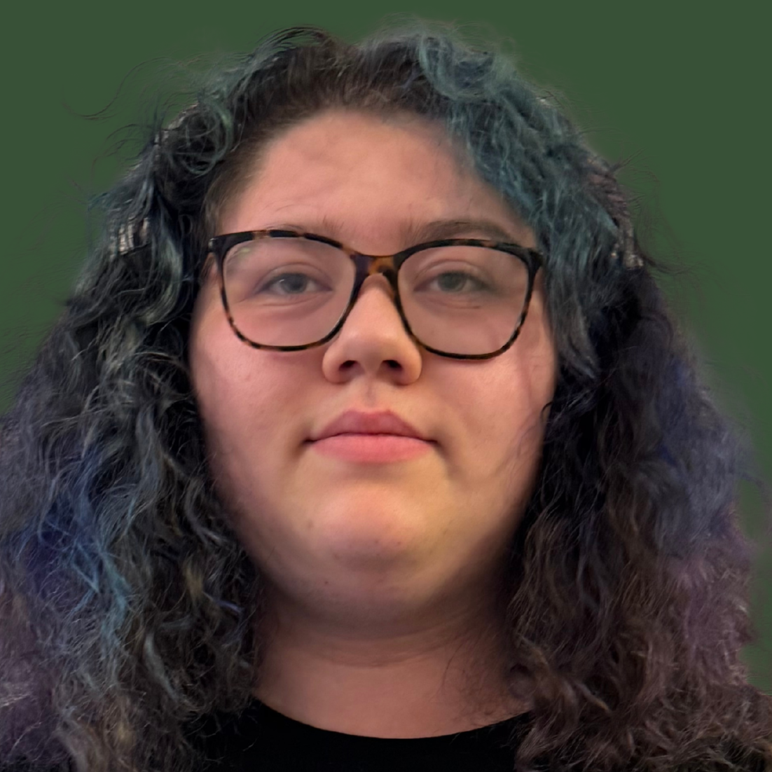 Person holds a certificate for Student of the Month. Green background, black t-shirt, and curly hair.