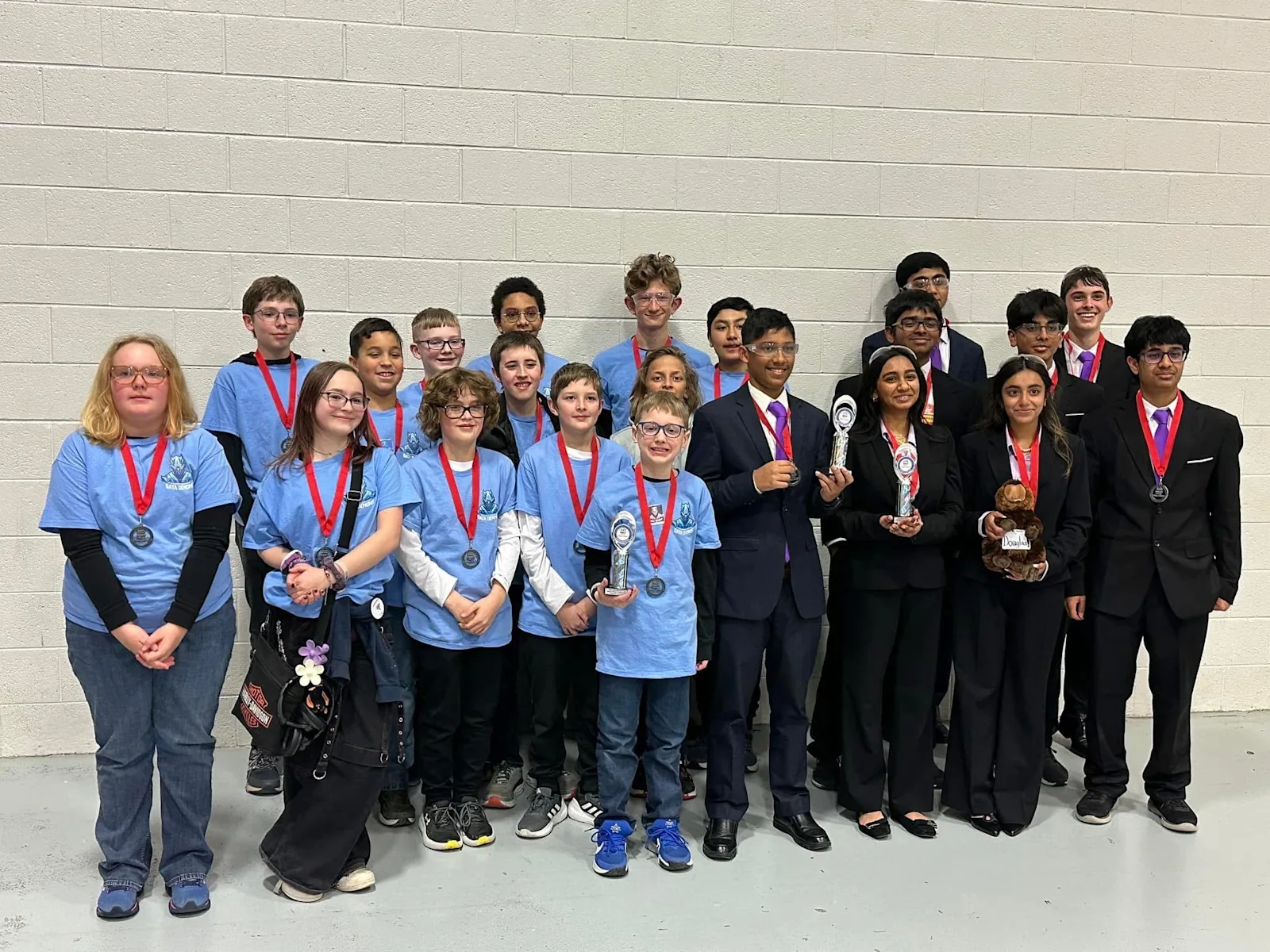 students with medals smiling