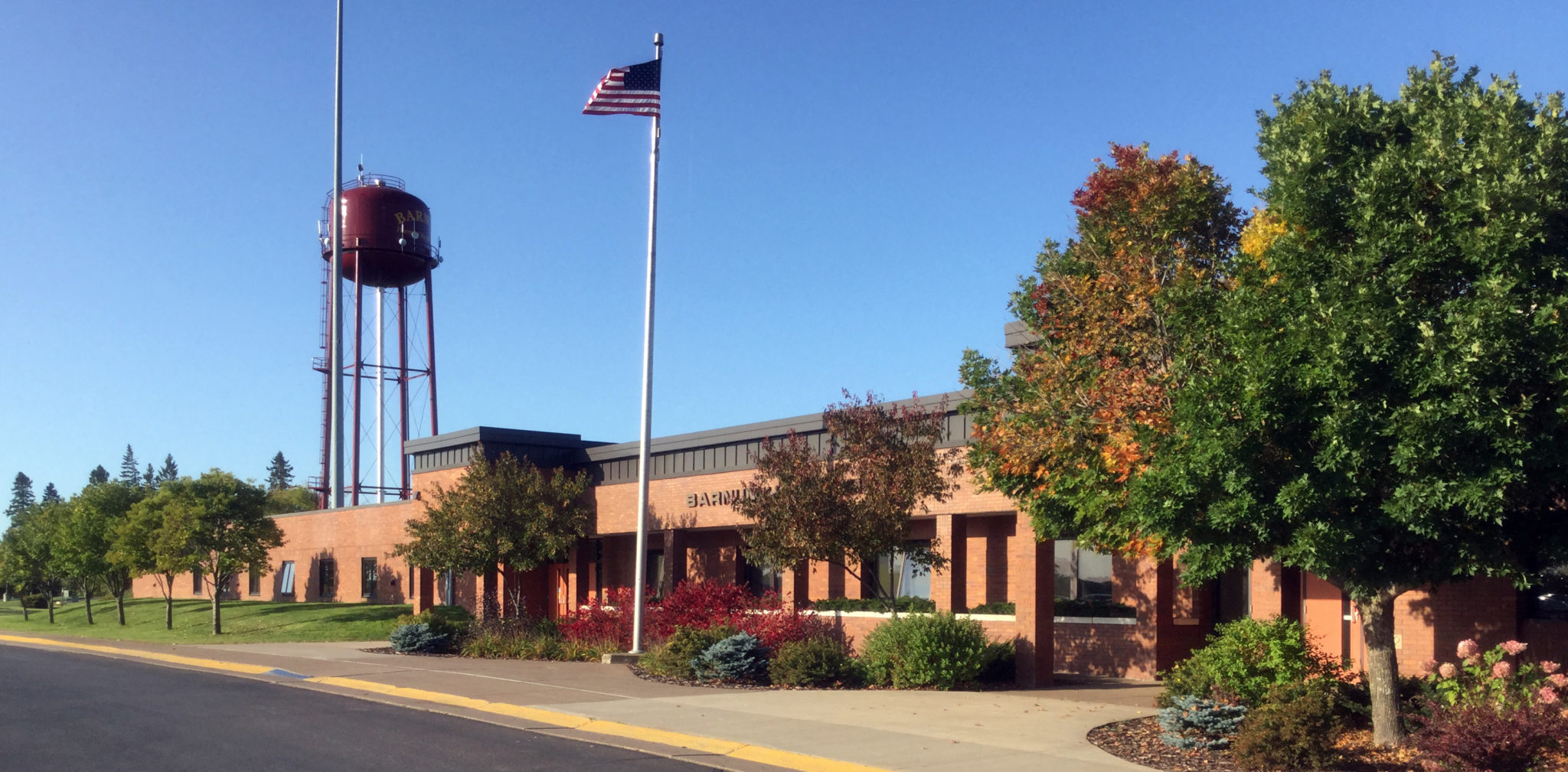 A building stands prominently with a water tower visible in the background, showcasing a blend of architecture and utility.
