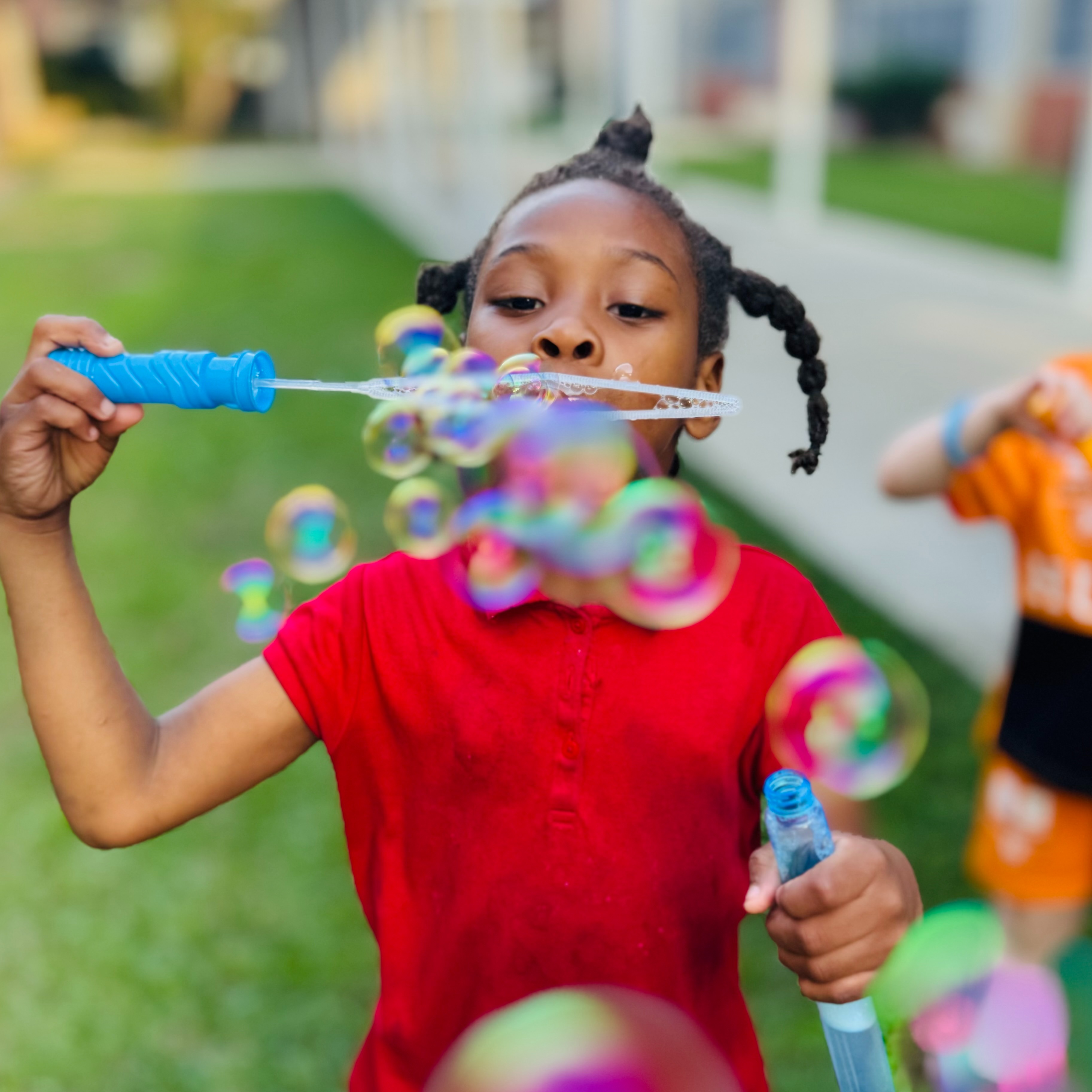 girl blowing bubbles
