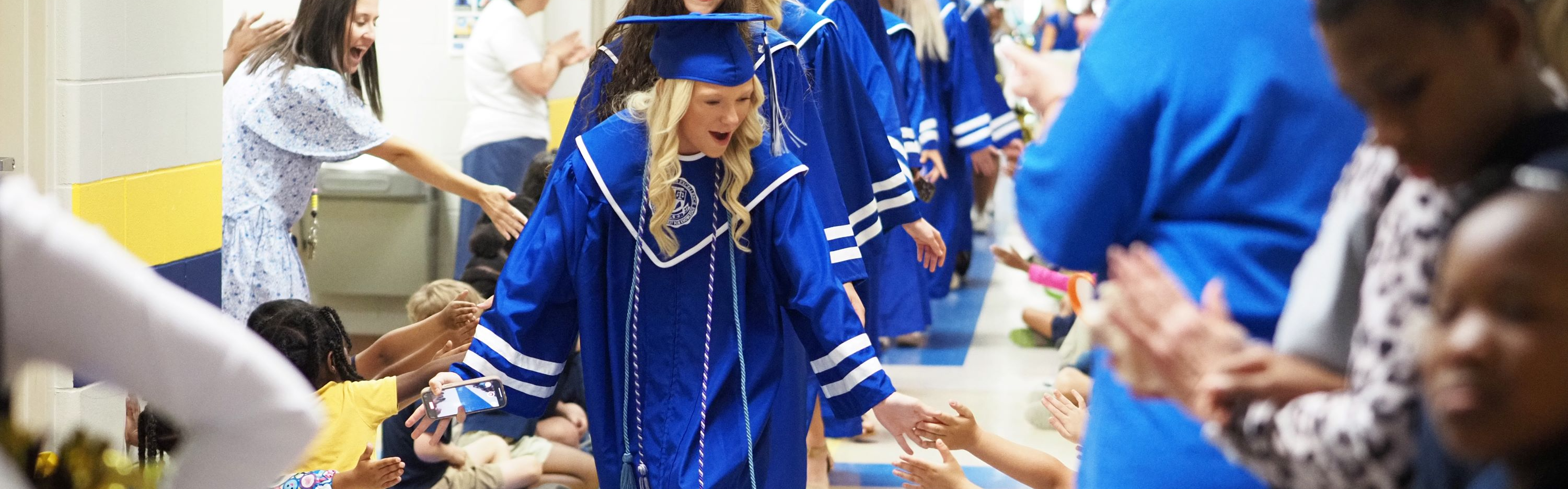 Baker graduates walking through Taylor White Elementary