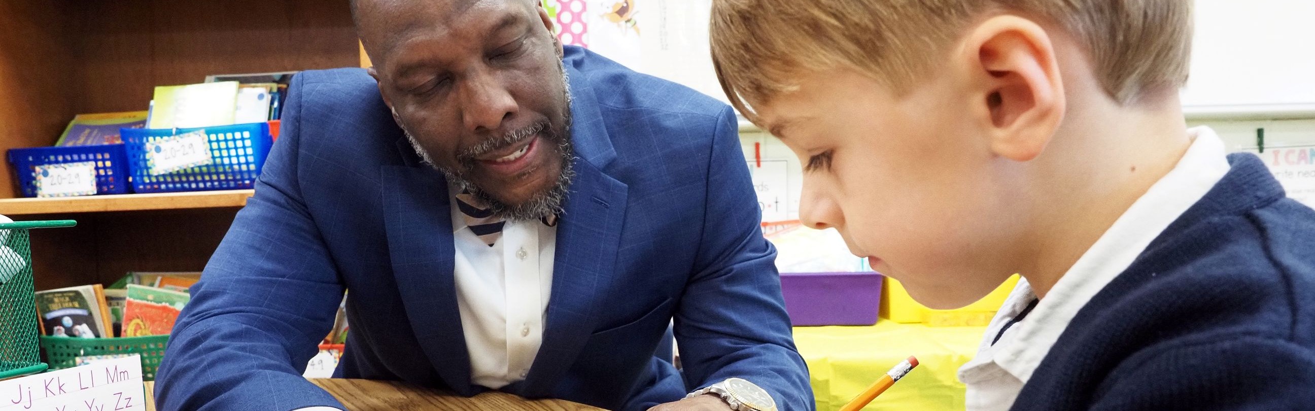 Mr. Threadgill helping a student with his worksheet