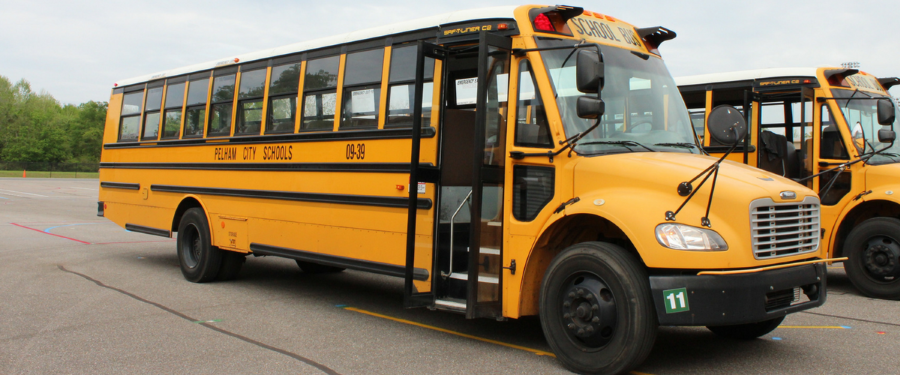1. Two yellow school buses parked side by side, ready to transport students to and from school.   2. A pair of yellow school buses, brightly colored, standing together in a school parking lot.  3. Two vibrant yellow school buses, positioned next to each other, awaiting students for their daily commute.