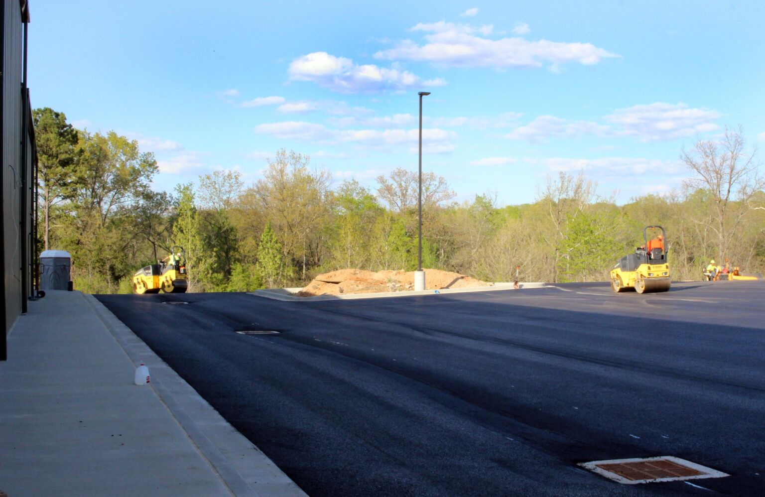 A parking lot filled with various construction equipment, showcasing machinery and tools in an organized layout.