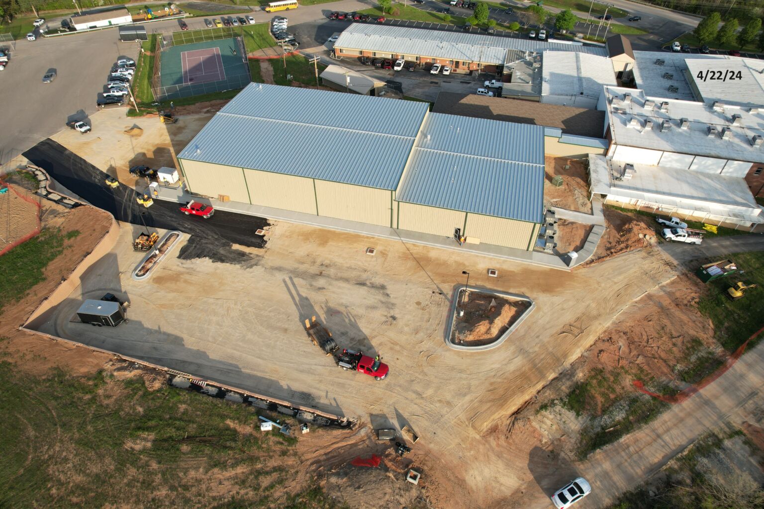 Aerial view of a construction site showcasing a building in progress, with cranes and scaffolding visible.