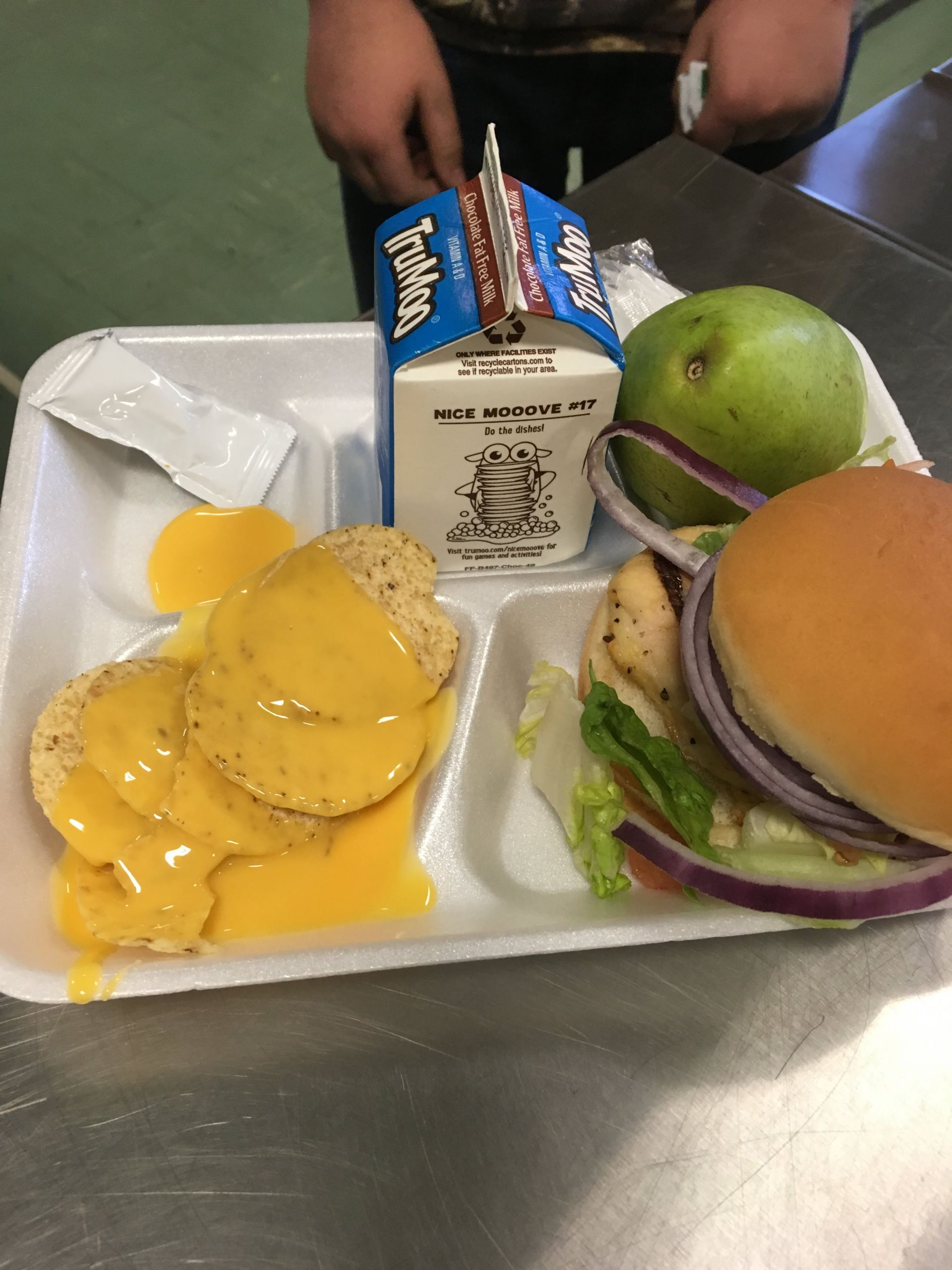 A tray featuring a hamburger, crispy fries, and a refreshing drink, arranged appetizingly for a meal.