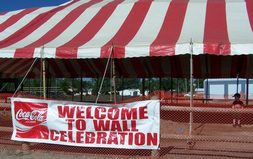 A festive banner reading "Welcome" hangs from a red and white tent, creating a celebratory atmosphere for the event.