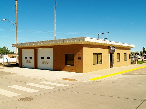 A compact structure with two garage doors located on the side, highlighting its functional design.